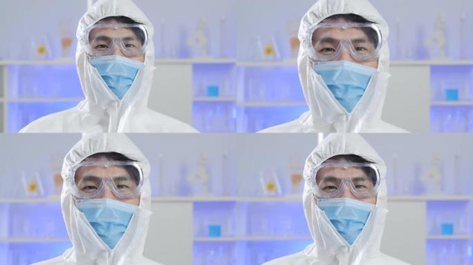 亚洲男性流行病学家的肖像，保护患者免受冠状病毒新型冠状病毒肺炎的微笑和穿着西装的面具看着相机。肖像，
