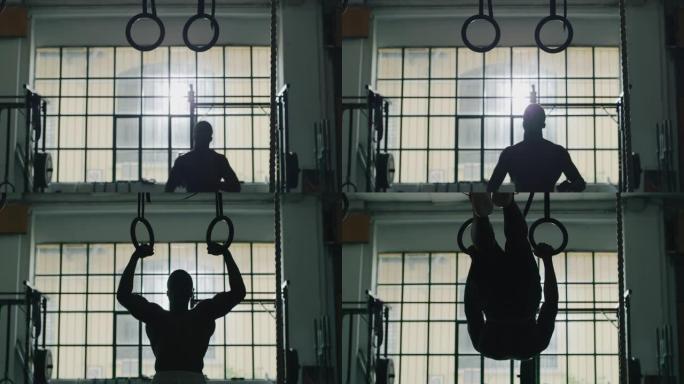 一名专业的年轻肌肉光着膀子的非洲男子的电影慢动作镜头正在带戒指的健身房练习太极拳锻炼
