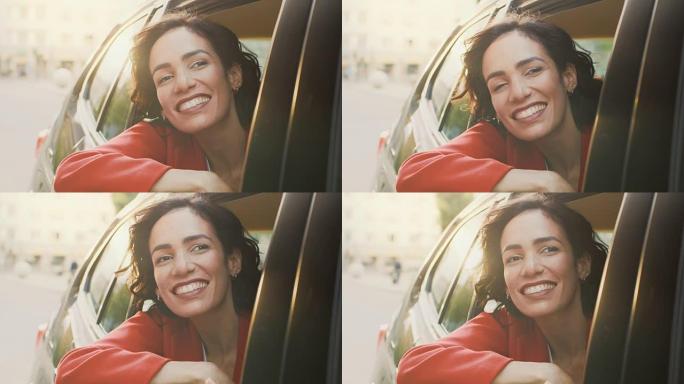 快乐美丽的女人坐在汽车后座上，从敞开的窗户望向大城市的奇观。旅行女孩体验世界的魔法。从车外拍摄的相机