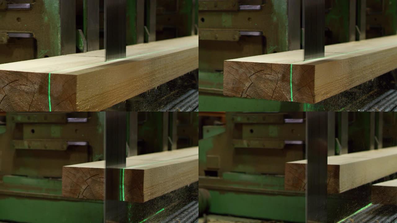 用工业锯木厂从原木上锯切木板的特写