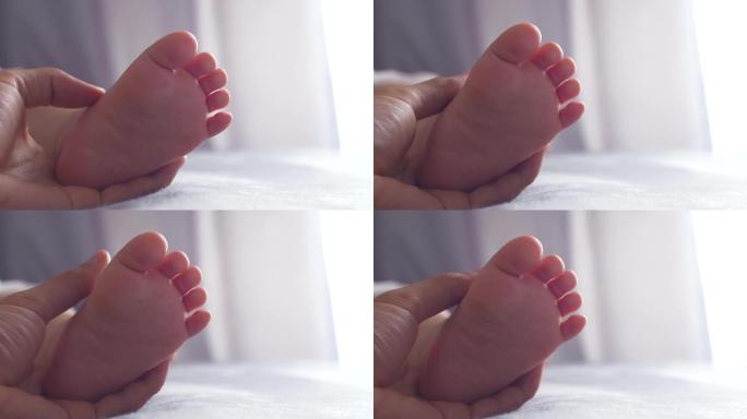 婴儿脚在母亲的手中轻轻触摸