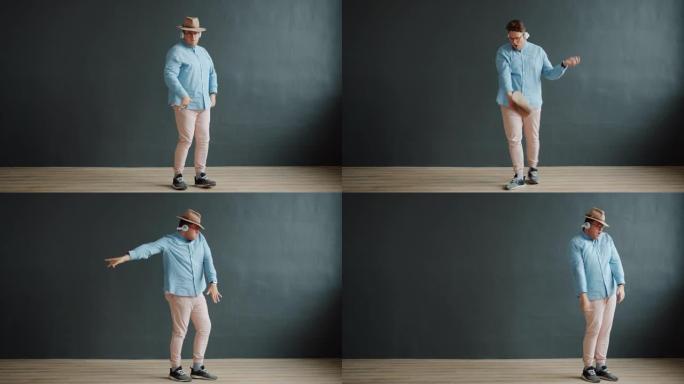 男性成人跳舞机器人跳舞戴着帽子和眼镜在深灰色背景