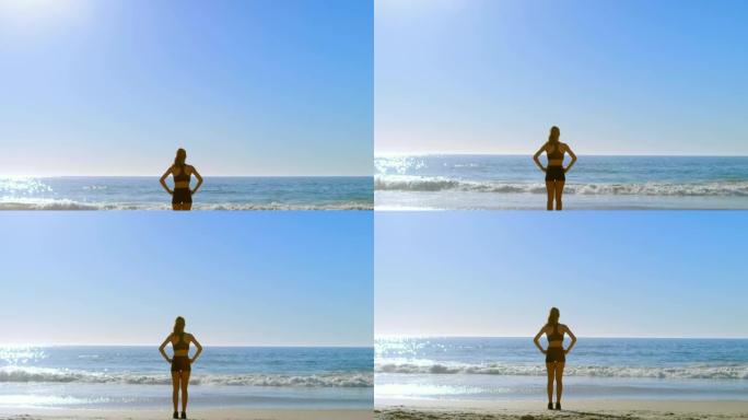 健康的女人站在海滩4k