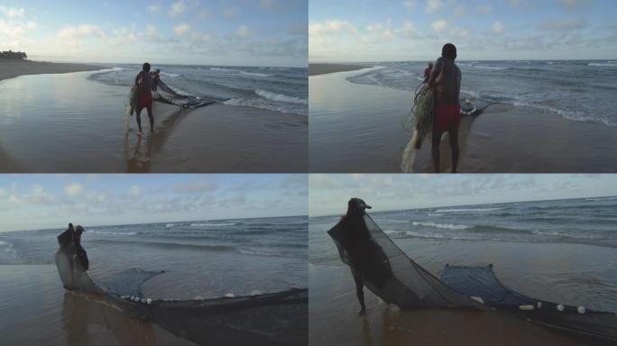 莫桑比克浅海冲浪两个自给自足的渔夫的4k视图
