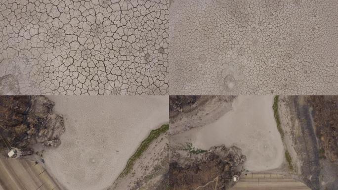4k空中缩小由于气候变化和全球变暖造成的干旱大坝破裂的泥浆表面的美丽图案的圆形视图
