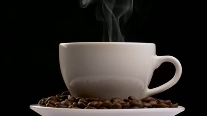 旋转咖啡杯，蒸汽和咖啡豆。慢动作，黑色背景