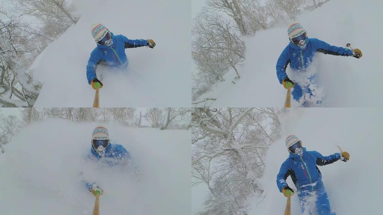 自拍照: 年轻的自由滑雪者切碎了日本山区的深雪。