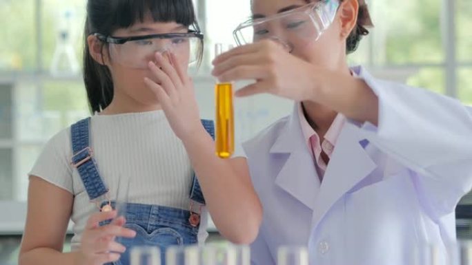 亚洲学生在科学实验实验班学习。教育主题
