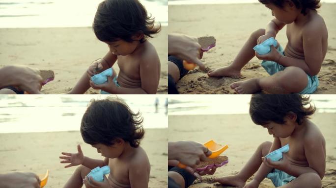 亚洲家庭在沙滩上玩沙子