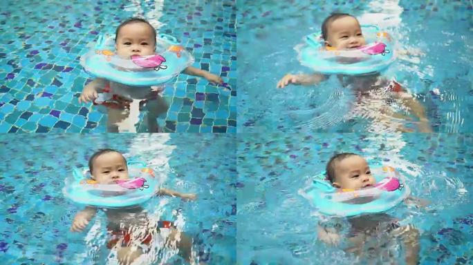 可爱的婴儿在游泳池上游泳课