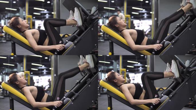 亚洲女性在健身房做腿部按压运动