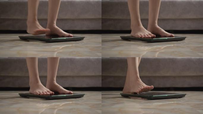 亚洲女性脚踩在数字体重秤上检查她的体重