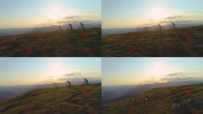 无人机: 在阳光明媚的春日，一群山地自行车手在草木山上加速行驶。
