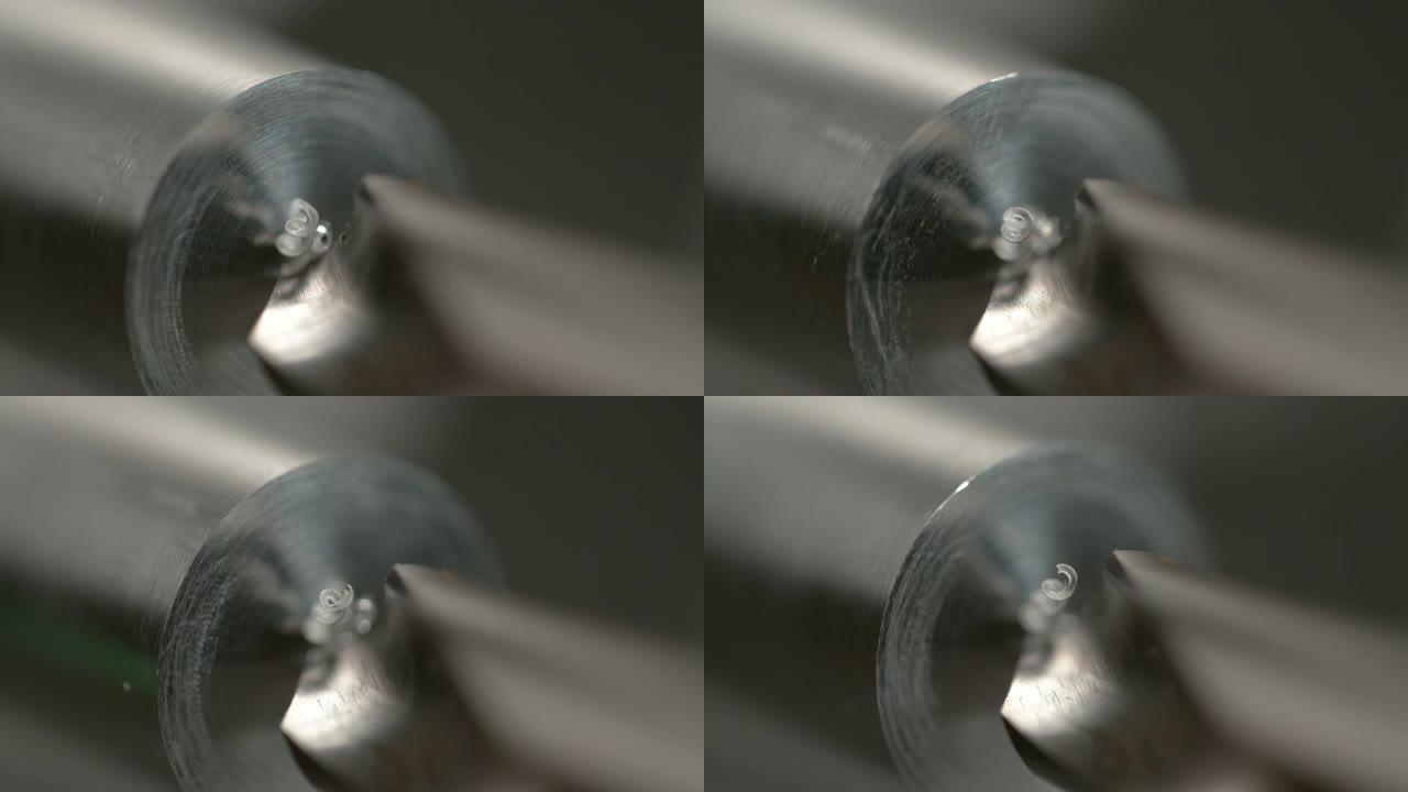 宏观，dop: 锋利的钻头在闪亮的金属棒中间钻一个洞。