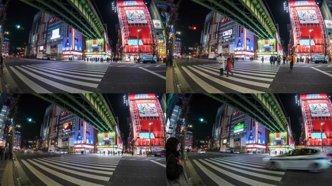 人们步行的4k时间流逝在日本东京的秋叶原的街道交叉路口与汽车交通交叉路口。日本文化与电城购物区概念