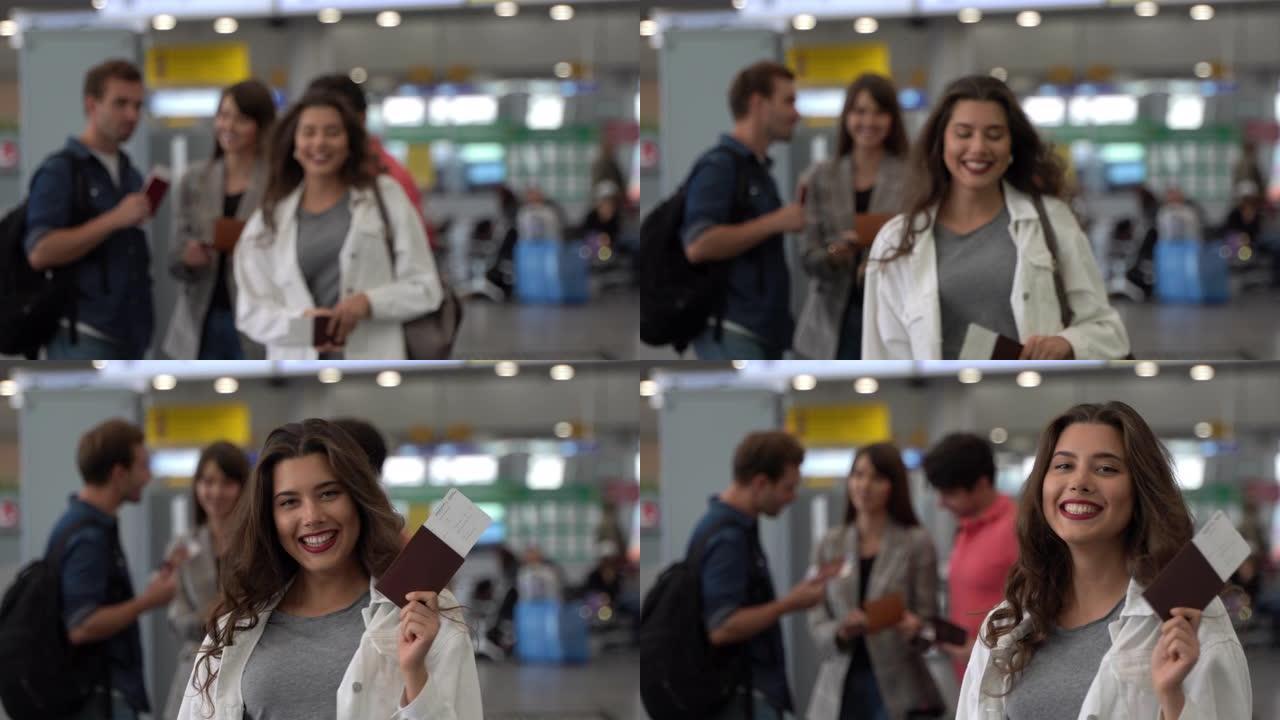 准备在机场旅行的夫妇和美丽的女人拿着护照和登机牌走向相机微笑