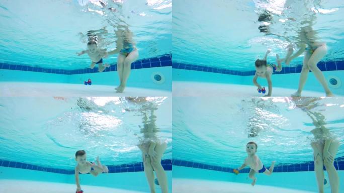 孩子在母亲的控制下在水下潜水