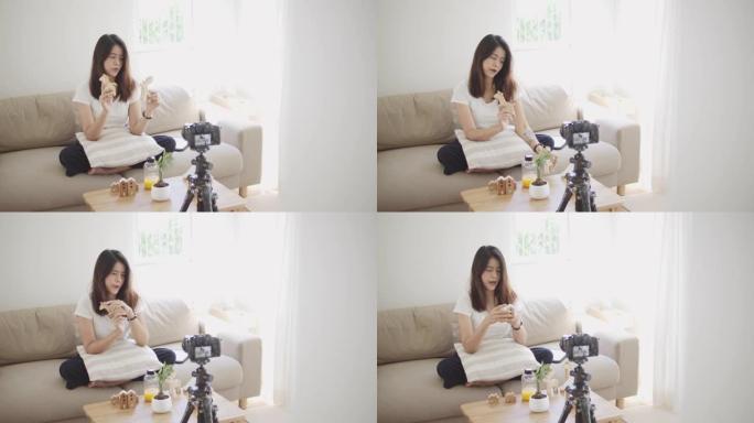 亚洲女性博客作者用相机录制视频并在家里聊天