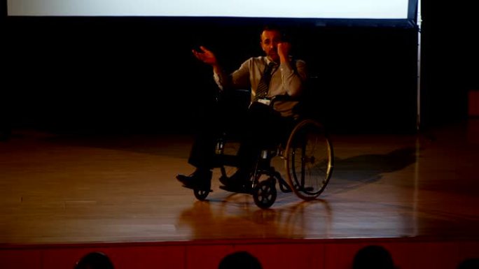成熟的高加索残疾商人在4k礼堂的商业研讨会上发言
