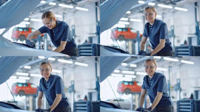 美丽的赋能女汽车修理工正在为服务中的车辆工作。她用棘轮时看起来很开心。专家戴着安全眼镜。她看着相机微