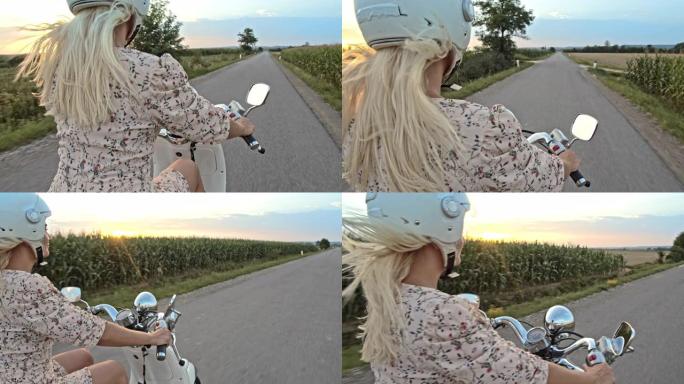日落时分，SLO MO Mid成年妇女在乡间小路上骑踏板车