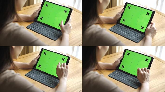 女人看着平板电脑绿色屏幕