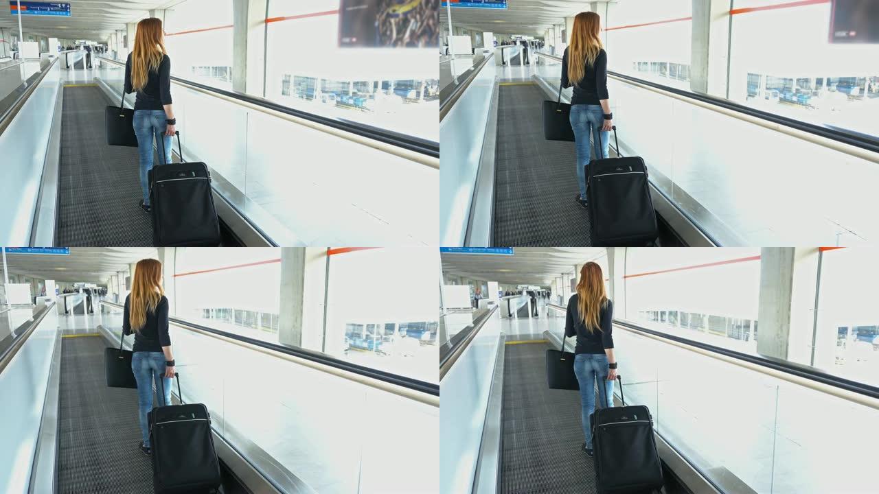 女旅行者在机场移动人行道上，带着轮子手推车手提箱和钱包，穿过走廊朝飞机移动
