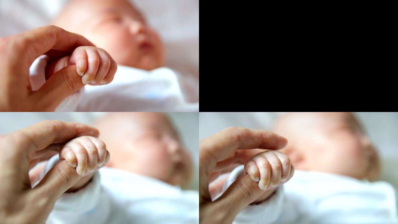 新生婴儿握着父亲的手