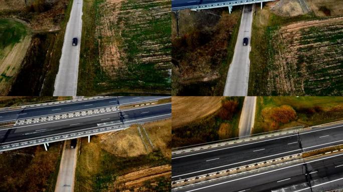 空中俯视图，摄像机跟踪在大气公路旅行中沿着侵蚀的田野和高速公路行驶的黑色汽车。