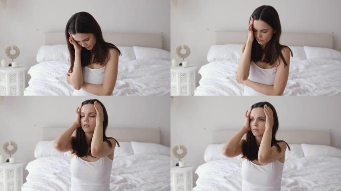 躺在床上清醒的不安妇女患有失眠头痛