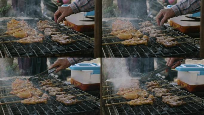 串鸡肉块在烤架上烤，冒烟