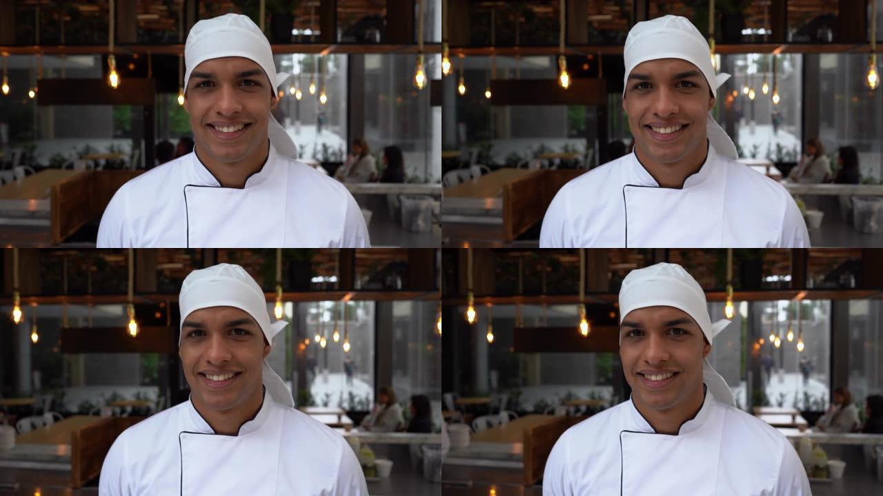 面对镜头的餐厅男厨师的特写非常高兴