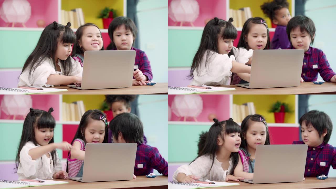 慢动作-一群在教室里使用笔记本电脑的孩子，多种族的年轻男孩和女孩在小学学习时很高兴使用技术。孩子们使