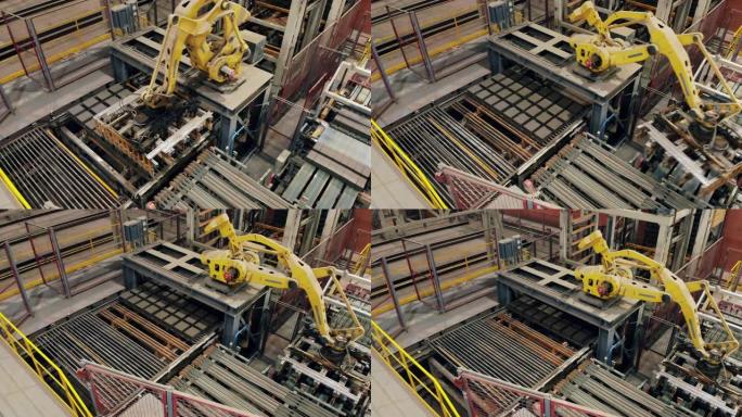 现代机械臂正准备运送砖块。现代自动化工厂设备。