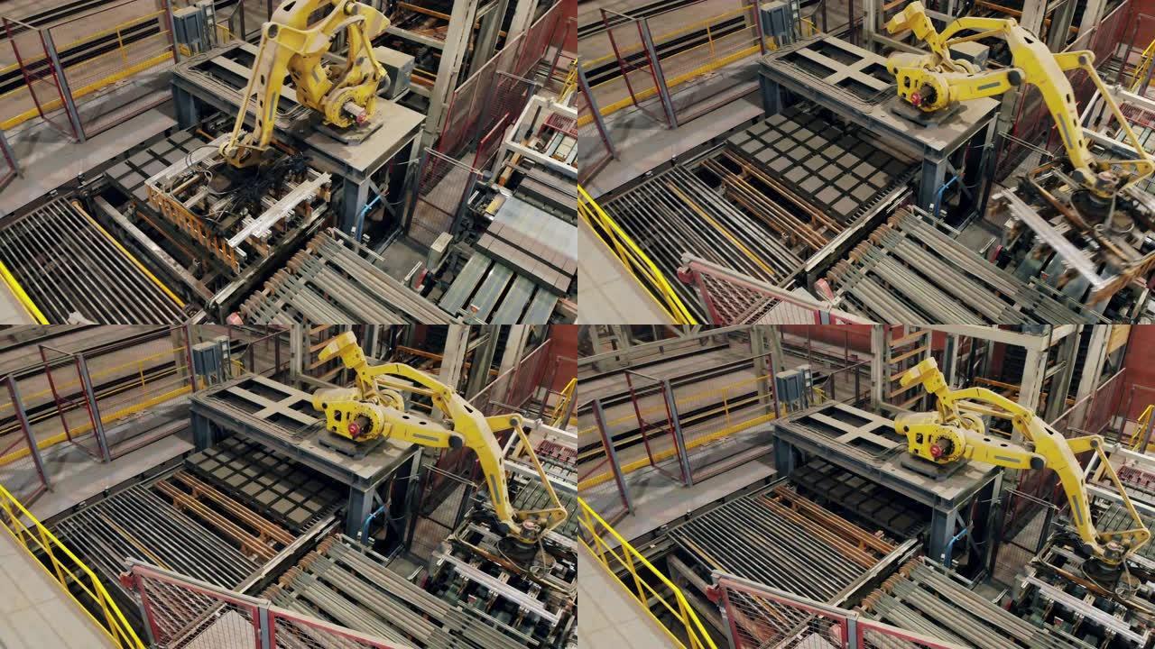 现代机械臂正准备运送砖块。现代自动化工厂设备。