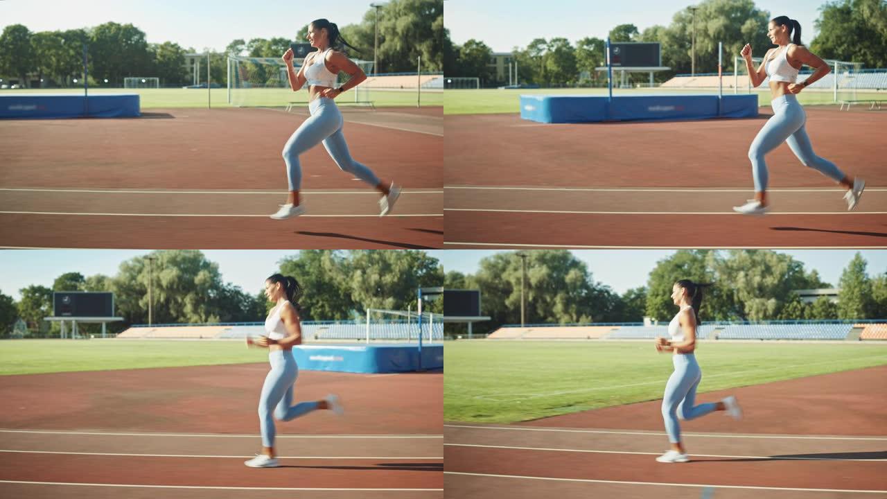 穿着浅蓝色运动上衣和打底裤的美丽健身女子在体育场慢跑。在一个温暖的夏日下午，她跑得很快。运动员在做她