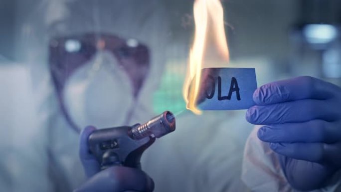 与疾病概念作斗争。实验室工作人员着火了单词 “ebolaa”