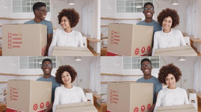 微笑的年轻夫妇在搬家日将箱子搬入新家的肖像