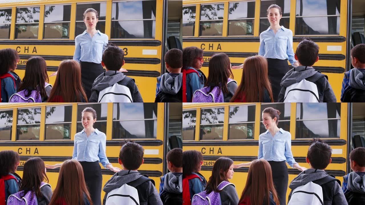 学校老师在孩子上校车之前与他们交谈
