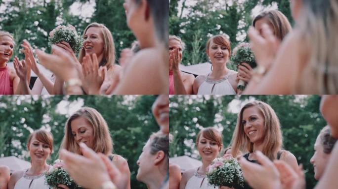 欢快的女人在婚礼上捕捉花束