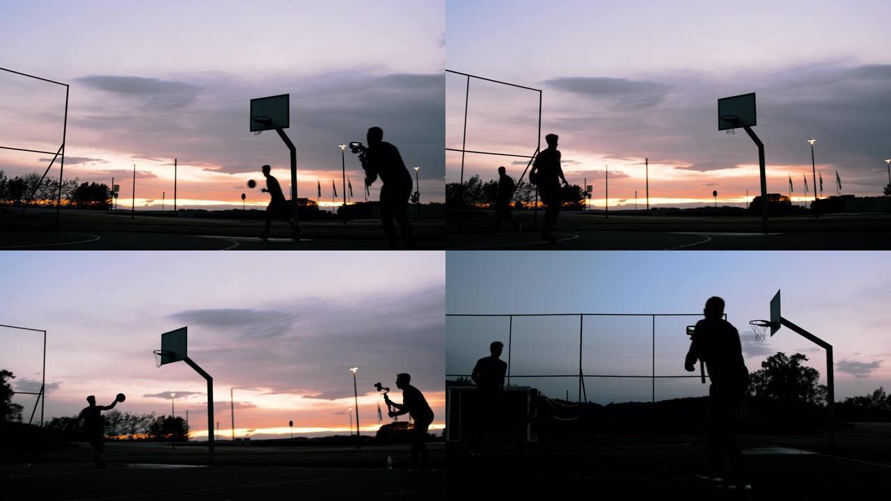 男子女士拍摄篮球运动员在黄昏时在室外篮球场上射击篮筐