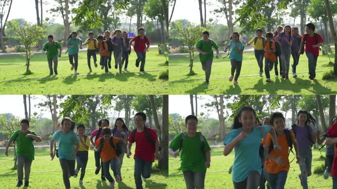 在阳光明媚的夏日，男孩和女孩在放学后穿着便装在公园里跑步。