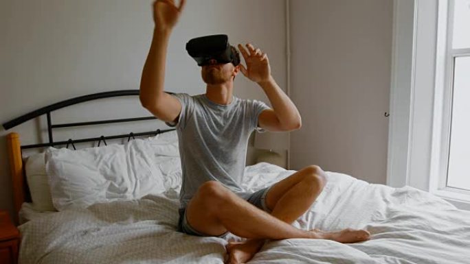 男子在卧室4k床上使用虚拟现实耳机