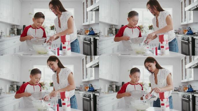 十几岁的西班牙裔男孩和他的母亲在厨房里做蛋糕混合，特写