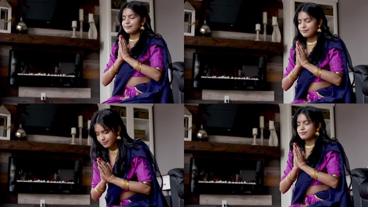 美丽的印度女性在家里祈祷