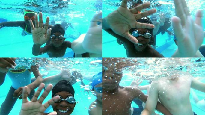 多种族儿童在水下挥舞着相机
