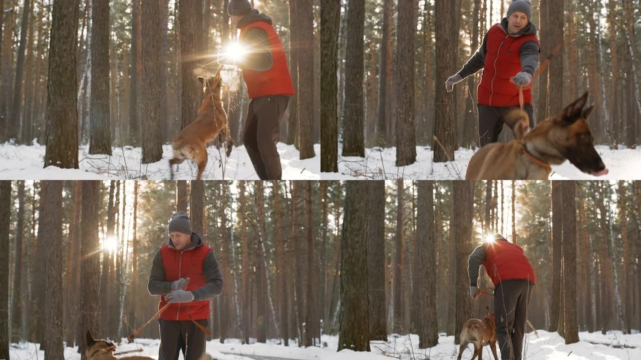 男子在冬季森林中与狗玩耍