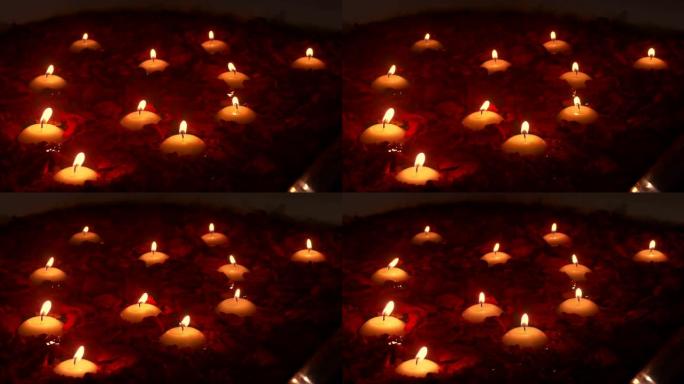 蒸汽浴缸中的香薰蜡烛和玫瑰花瓣