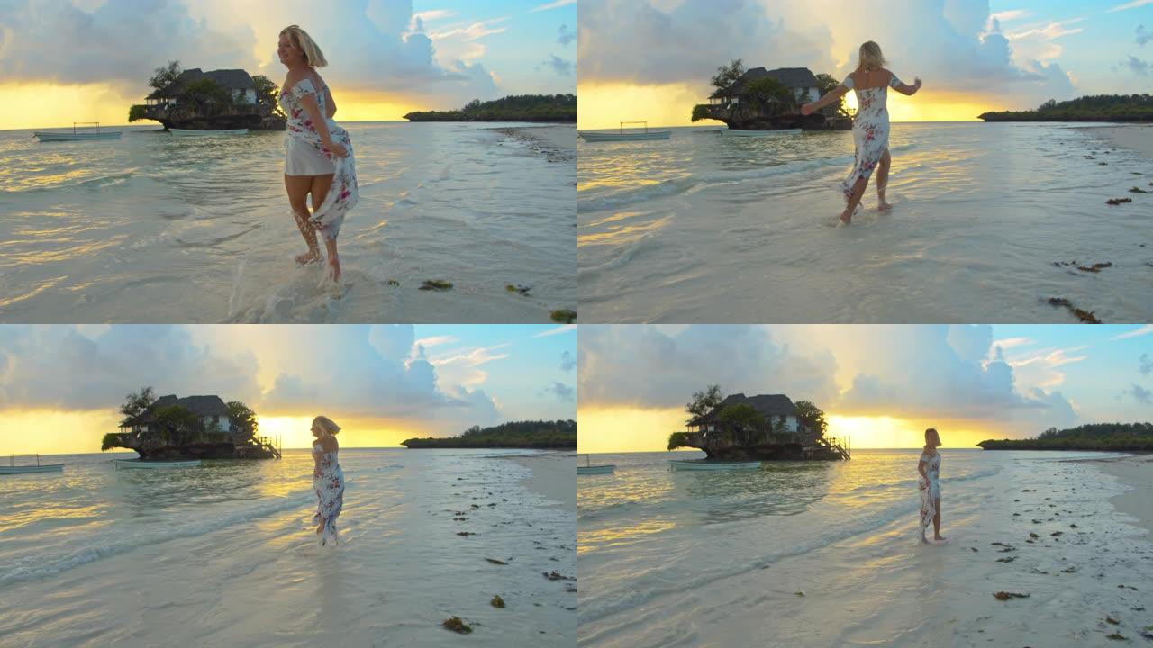 黄昏时在沙滩上奔跑的SLO MO欣喜若狂的女人