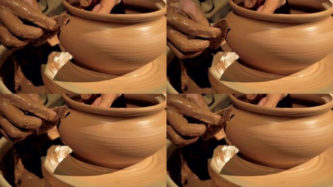 陶器工人抚平花瓶，特写。